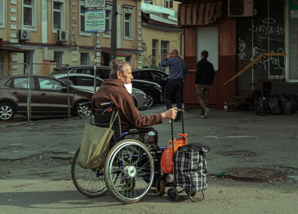 man in black jacket riding on bicycle during daytime